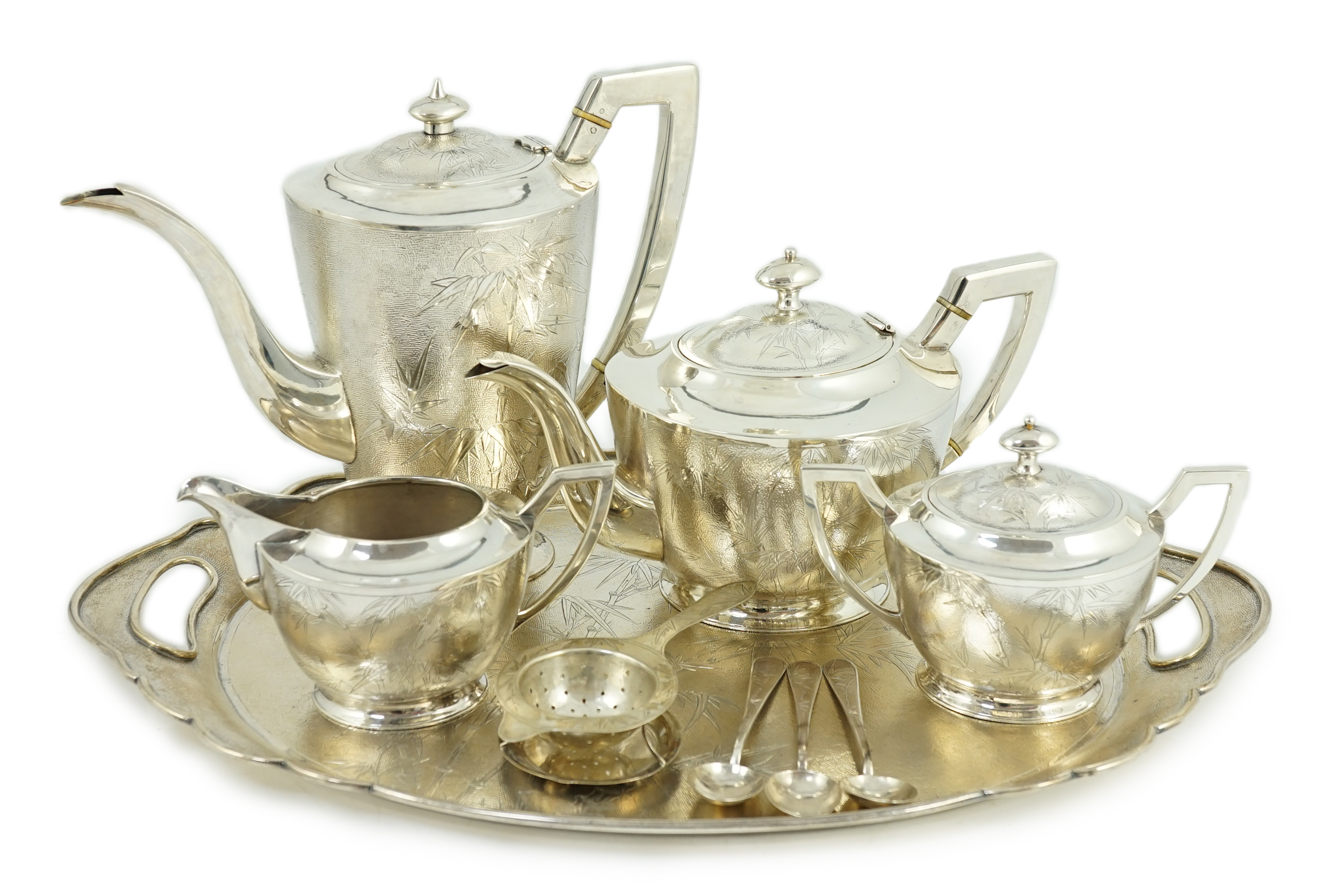A late 19th/early 20th century Chinese Export sterling silver four piece tea and coffee service and matching oval tea tray, three teaspoons and a tea strainer, by Tack Hing, Hong Kong
